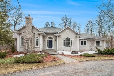 Custom-built bungalow set on a picturesque 1.98-acre wooded lot Image# 2