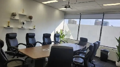 The conference room is big with natural light and windows Image# 7