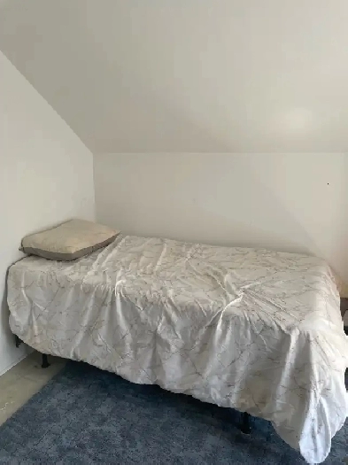 Room for rent with shared accommodations.